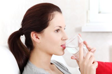 Beautiful woman holding a glass of water. clipart