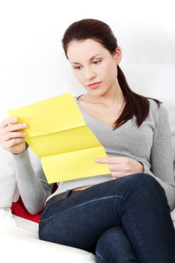 Beautiful woman having a look at the documents. clipart