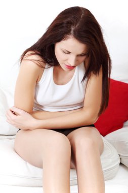 Beautiful woman having a stomach ache. clipart