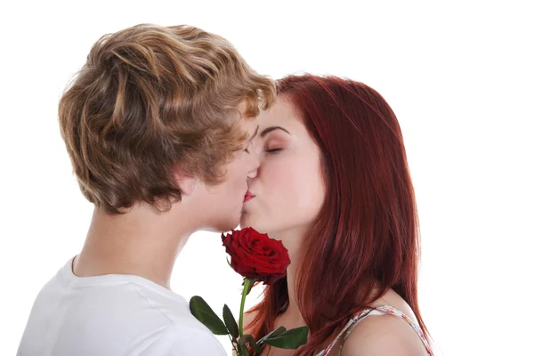 Kissing couple with rose. — Stock Photo, Image