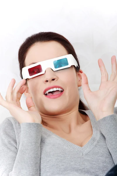 Smiling woman sitting on a sofa with 3D glasses. — Stock Photo, Image