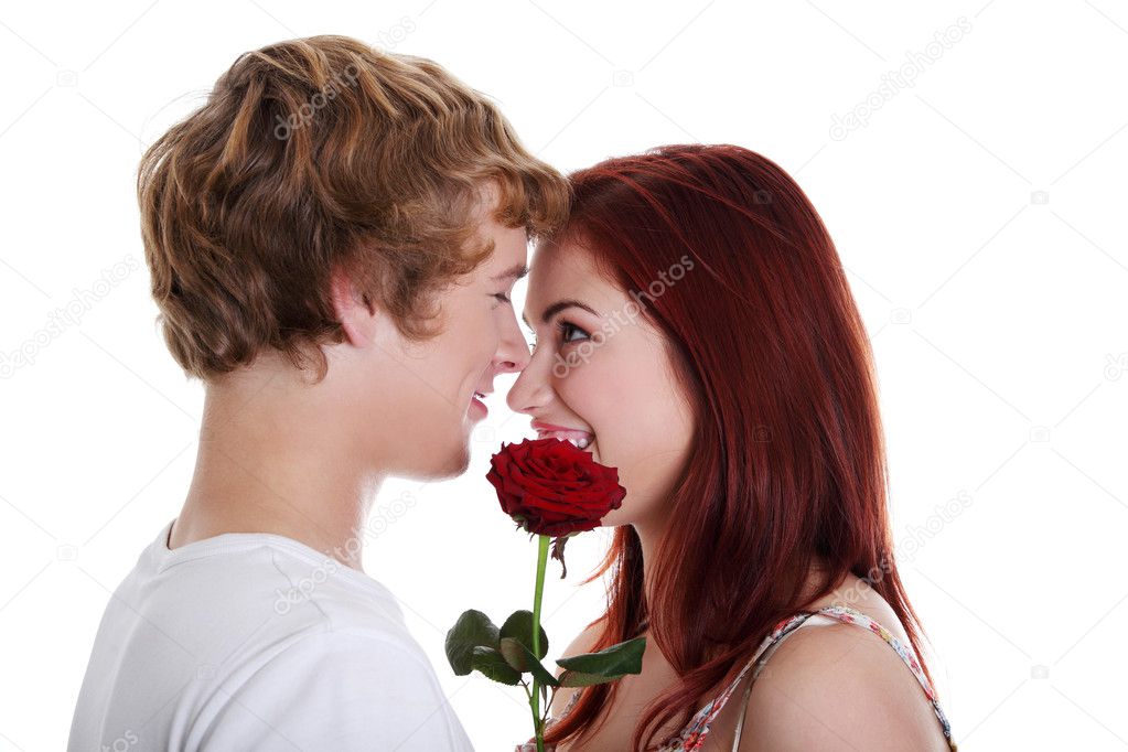 Young couple holding red rose.