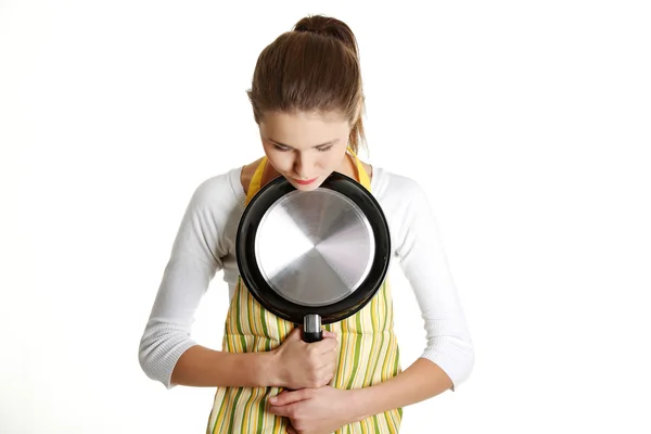 Worried female teen with a frying pan. — Stock Photo, Image