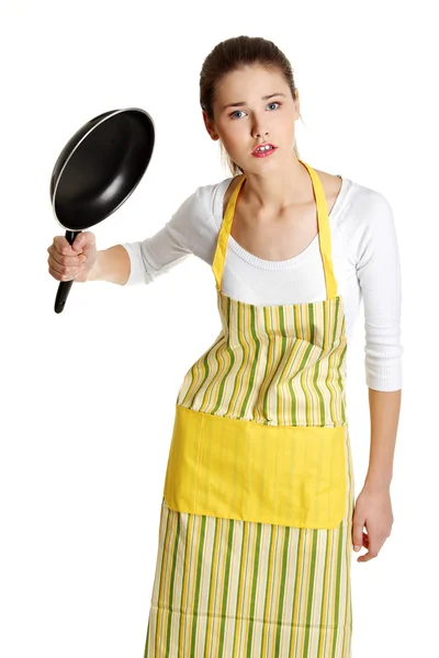 Upset female teen with a frying pan. — Stock Photo, Image