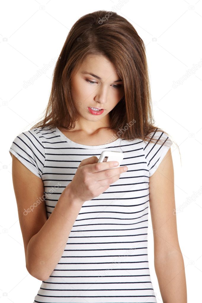 Surpriced caucasian teen with a mobile.