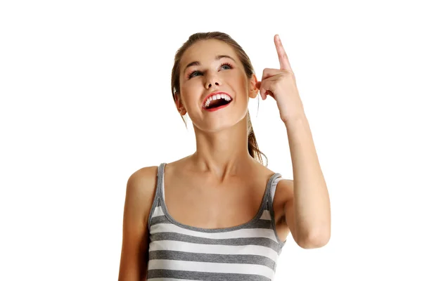 Female caucasian teen pointing up. — Stock Photo, Image