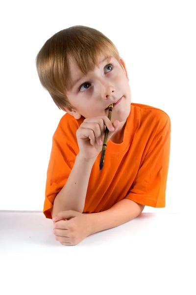 Boy with a pencil to think about something — Stock Photo, Image