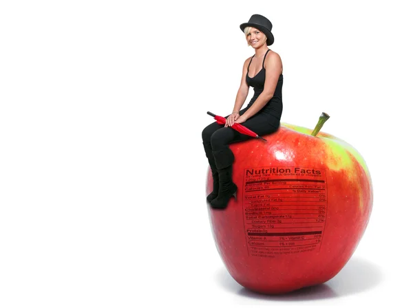 Nő ül a piros finom alma, a tápanyag-összetételre címkéje — Stock Fotó