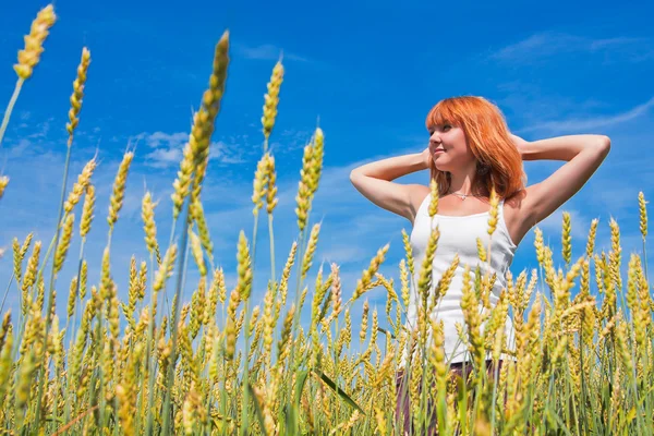 Beautiful young woman at wheat field — Stock Photo, Image