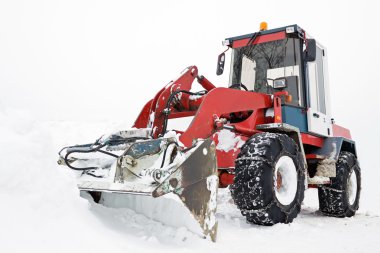 Tractor ready to work, winter snowplow clipart
