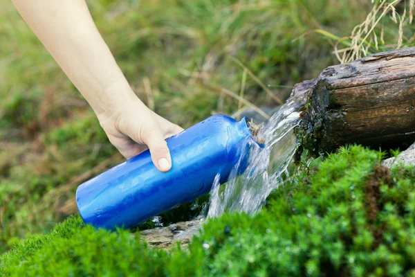 stock image Water bottle and stream on hike