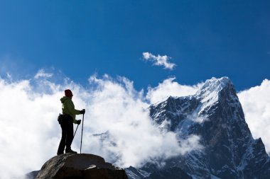 Woman hiking in Himalaya Mountains clipart