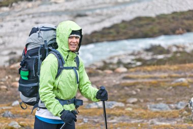 Woman hiking in mountains clipart