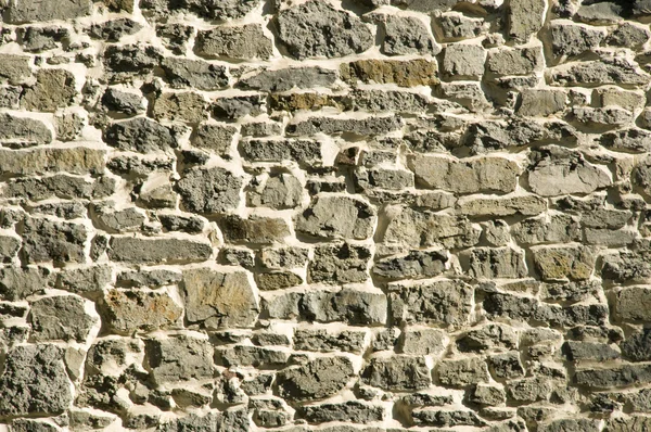 Parede de pedra de alvenaria primativa cinza — Fotografia de Stock