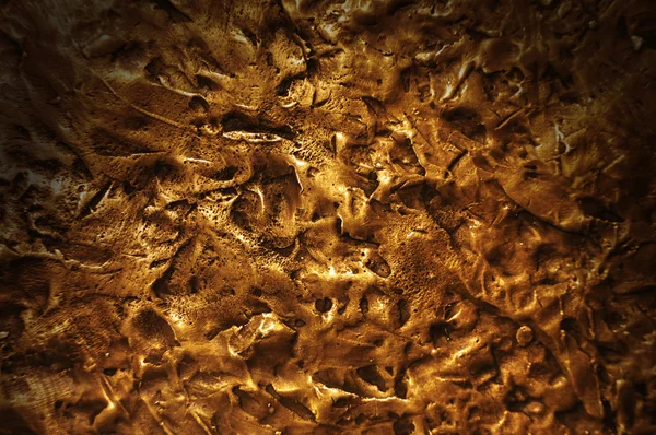 Bronze textured surface lit dramatically — Stock Photo, Image
