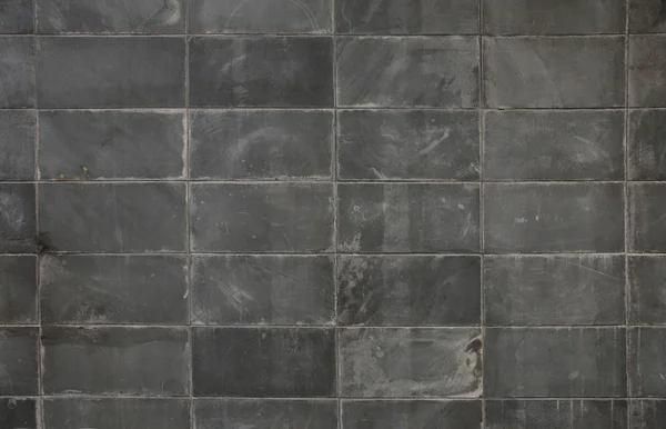 Mörk grå block vägg bakgrund — Stockfoto