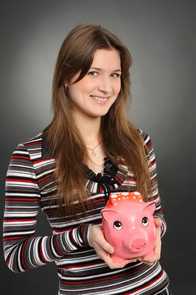 Woman with a piggybank — Stock Photo, Image