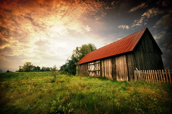 Sunset by an old barn — Stock Photo, Image
