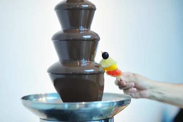 Рідкий шоколадний фонтан і свіжі фрукти на паличці — стокове фото