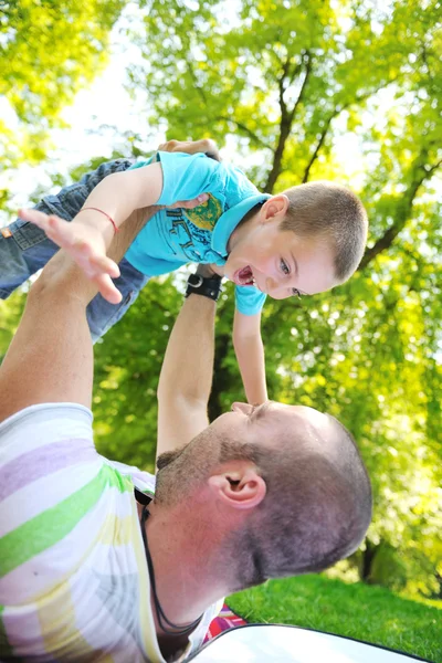 Šťastný otec a syn se bavit v parku — Stock fotografie