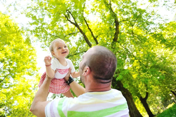 Man and baby playing in park — Stock Photo, Image
