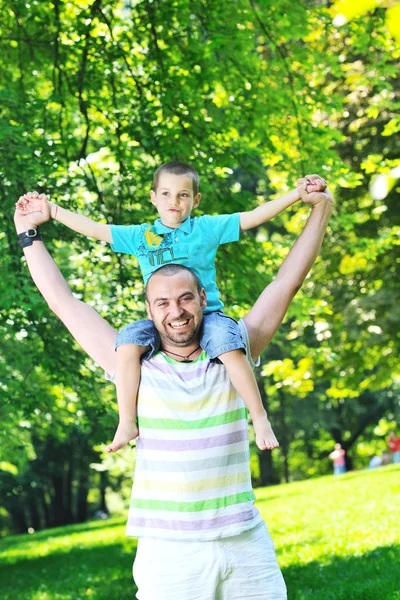 Šťastný otec a syn se bavit v parku — Stock fotografie