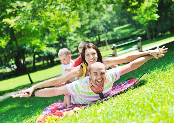 stock image Happy young couple with their children have fun at park