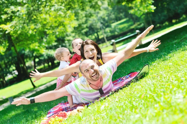 stock image Happy young couple with their children have fun at park