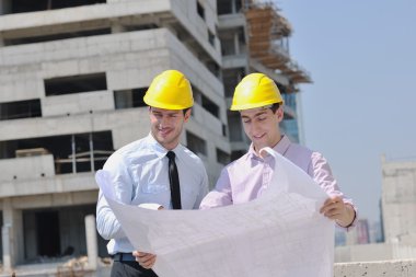 Team of architects on construciton site clipart