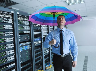 Young it engeneer in datacenter server room clipart