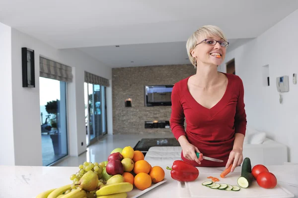 Gelukkig mooie blonde vrouw bereiden voedsel in de keuken — Stockfoto