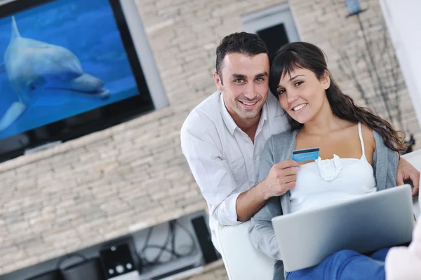 stock image Joyful couple relax and work on laptop computer at modern home