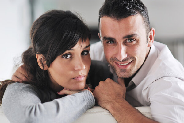 Relaxed young couple watching tv at home