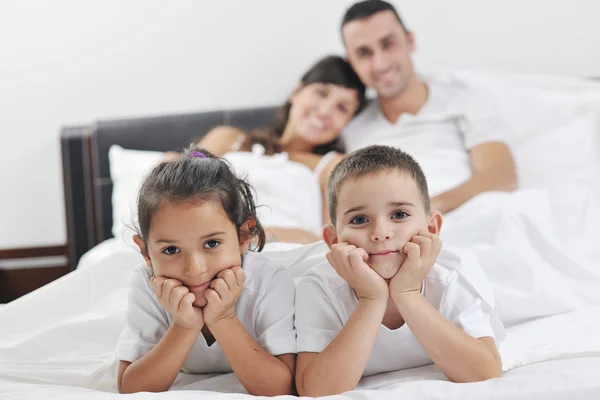 Happy young Family in their bedroom — Stock Photo, Image