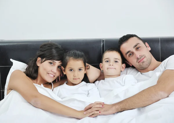 Happy young Family in their bedroom — Stock Photo, Image