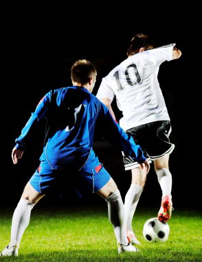 Football players in action for the ball