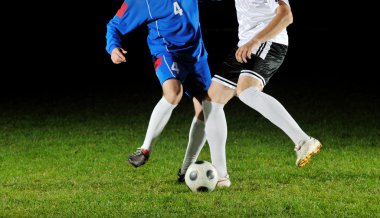 Football players in action for the ball