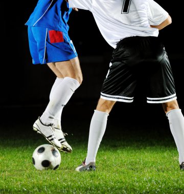 Football players in action for the ball