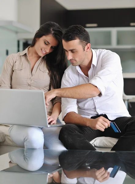 Joyful couple relax and work on laptop computer at modern home — Stock Photo, Image