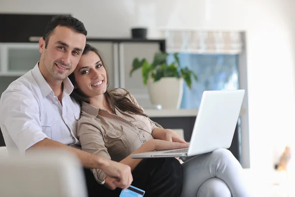 Casal alegre relaxar e trabalhar no computador portátil em casa moderna — Fotografia de Stock