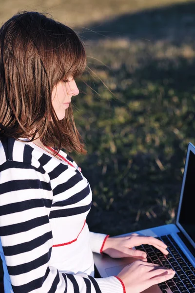 Молодая девушка работает на открытом воздухе ноутбука — стоковое фото