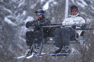 Winter fun on a chair lift clipart