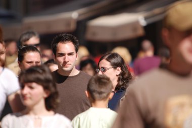 Happy man walking in crowd clipart