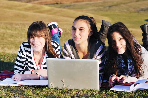 Group of teens working on laptop outdoor — Stock Photo, Image
