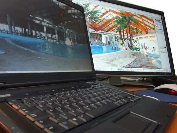 Laptop and big wide screen closeup — Stock Photo, Image