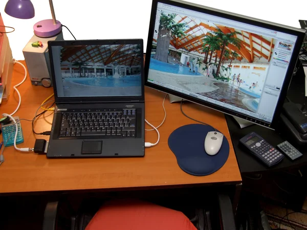 Laptop and big wide screen closeup — Stock Photo, Image