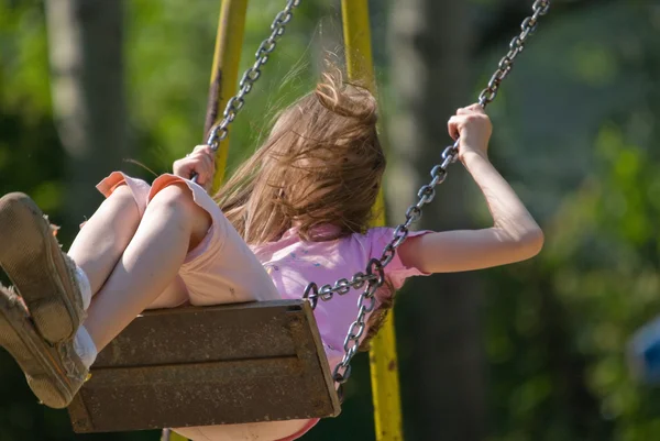 Happy girl swinging — Stock Photo, Image