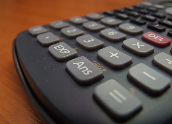Scientific calculator on the brown table — Stock Photo, Image