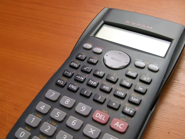Scientific calculator on the brown table — Stock Photo, Image