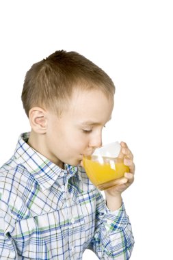 Boy drinking orange juice. clipart
